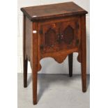 A small oak two door cupboard raised on square section tapering legs, width 45.5cm. CONDITION REPORT