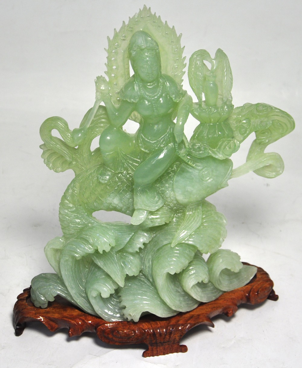 A polished green hardstone figure of a g