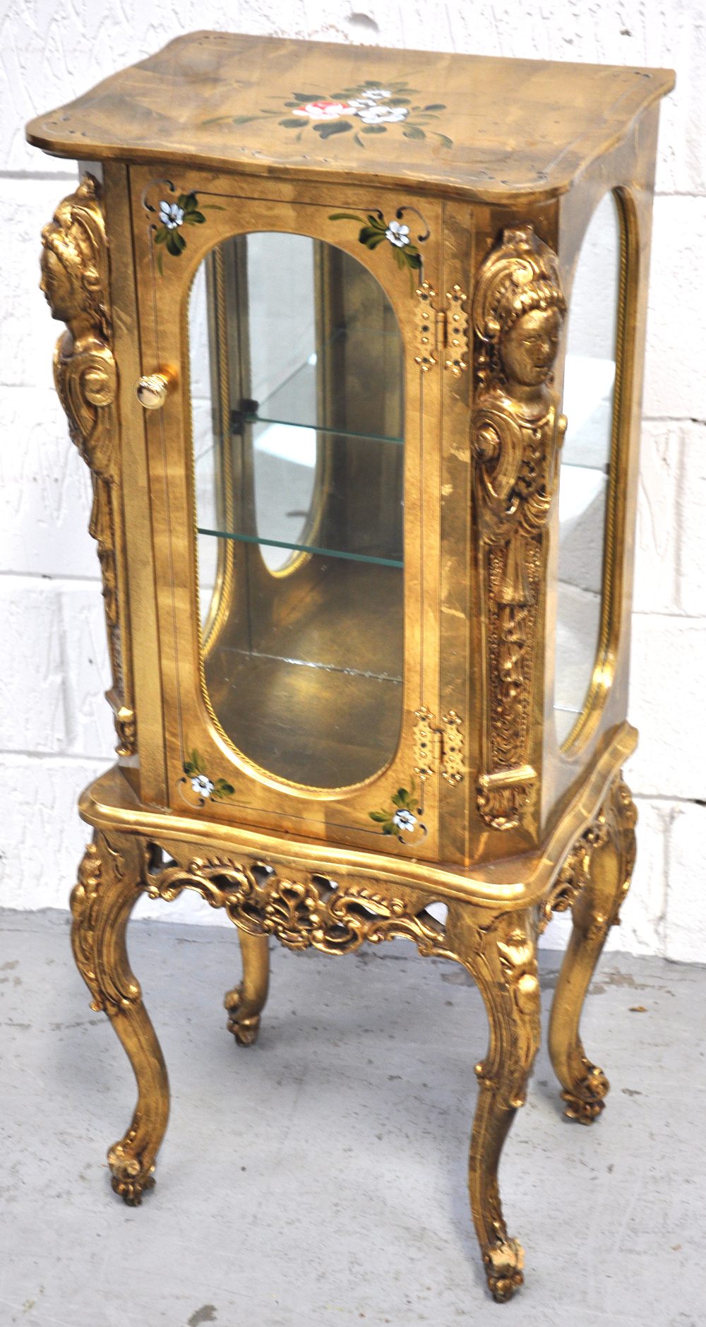 A small gilt painted single door glazed