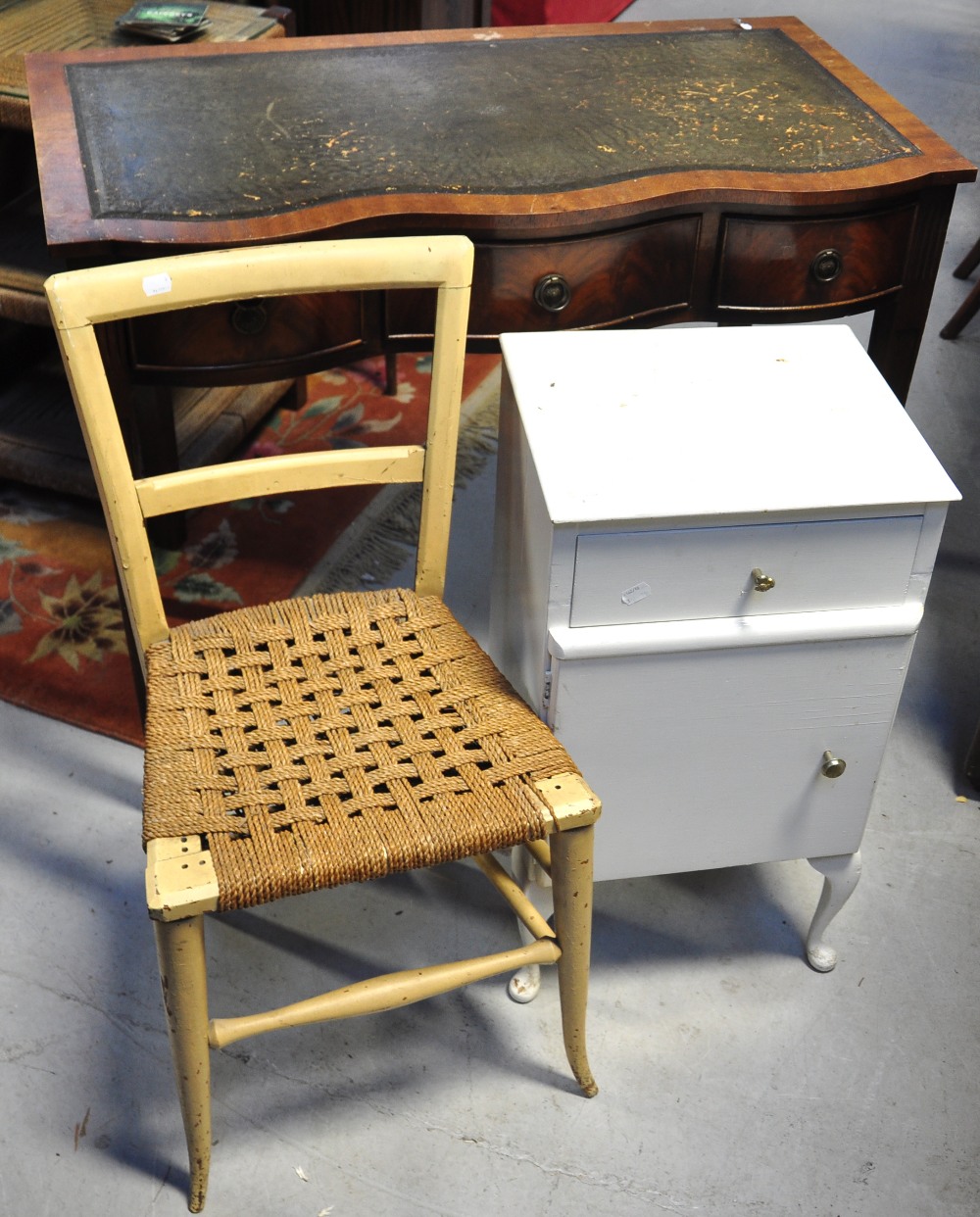 A retro bowfront leather top desk, a sma