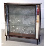 A retro 1950s cocktail cabinet with glaz