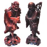 A pair of Oriental carved hardwood figur