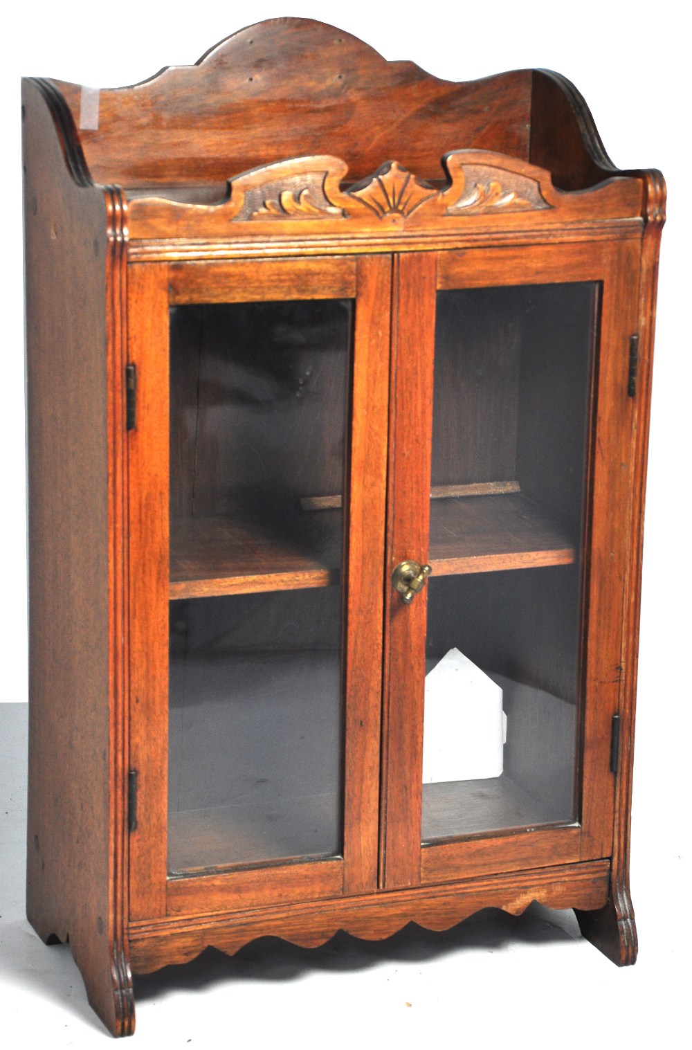 An Edwardian walnut two door glazed tabl