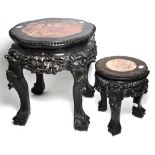 A pair of heavily carved Chinese hardwood stands with rouge marble inserts, terminating in claw