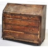 A George III fall front oak bureau with