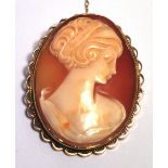 A 9ct gold framed oval cameo brooch decorated with the profile portrait of a young woman in