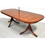 A reproduction yew wood extending dining