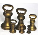 A set of six graduated brass bell weight