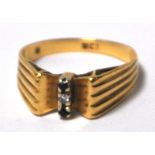 An 18ct gold ring, high shoulder set wit