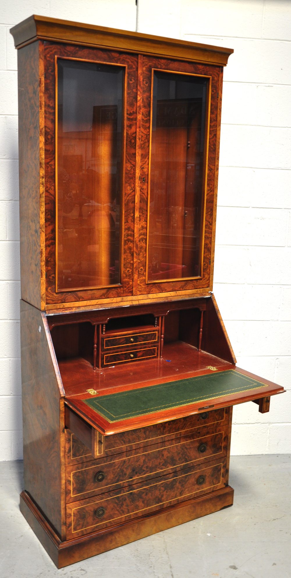 A reproduction walnut veneered bureau bo