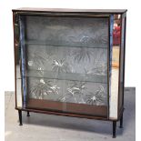 A retro 1950s cocktail cabinet with glaz