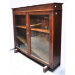 An oak two door glazed bookcase, width a