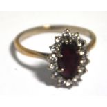 A 9ct gold ring set with central ruby su