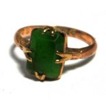 A 9ct gold ring set with central green h