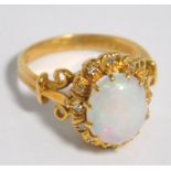 An 18ct gold opal and diamond ring, the