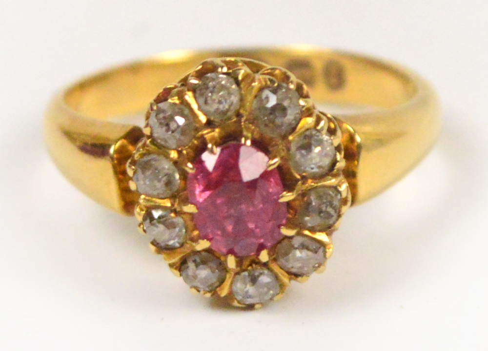 An 18ct yellow gold ring, the central pi