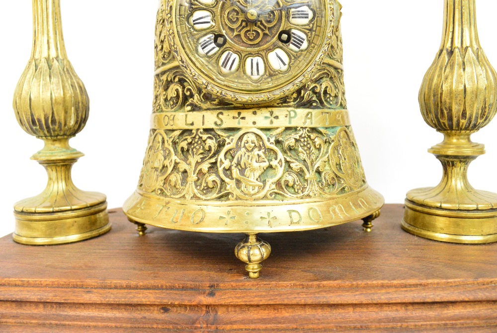 An unusual late 19th century French brass mantel clock, the bell shaped main clock section with