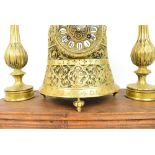 An unusual late 19th century French brass mantel clock, the bell shaped main clock section with