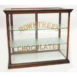 A late Victorian mahogany framed shop display cabinet, the moulded cornice above glazed sides, the