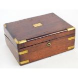 A 19th century mahogany veneered writing slope, with brass mountings to the corners, centred with