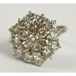 An 18ct white gold and diamond floral cl