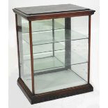 A late Victorian mahogany framed shop display cabinet, the moulded cornice above glazed sides,