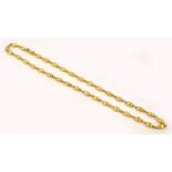 An 18ct gold oval textured bead necklace