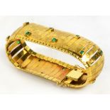 An 18ct gold emerald set broad bracelet,