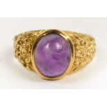 A 9ct gold ring with oval amethyst caboc