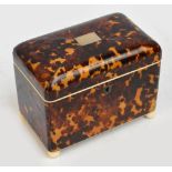 An early 19th century tortoiseshell domed two division tea caddy, the pewter strung hinged lid