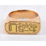 A yellow metal Egyptian inspired ring, t