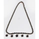 A 9ct gold garnet set necklace, the matc