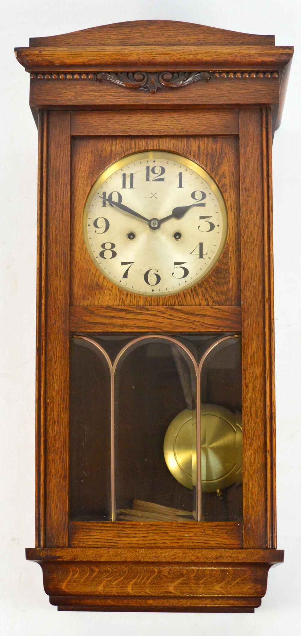 A 1930s oak wall clock, the circular sil