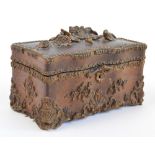 An unusual late 19th century American pressed oak tea caddy, the hinged lid surmounted with