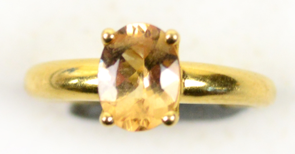 An 18ct yellow gold topaz ring, the oval