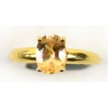 An 18ct yellow gold topaz ring, the oval
