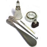 A silver handle shoe horn and button hook, a scent bottle with silver collar and a pin dish with