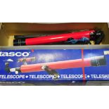 A modern boxed Tasco telescope.