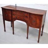A reproduction serpentine front sideboard two central drawers flanked by two cupboard doors, 133cm,
