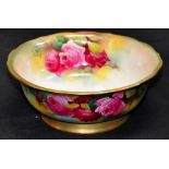 A Royal Worcester bowl decorated with sprays of roses and gilded, signed M. Hunt, puce marks to