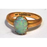 An 18ct gold ring set with an oval opal, approx weight 4.7g. CONDITION REPORT Size I and a 1/2.