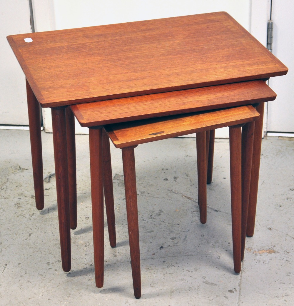 A nest of three teak tables by Bramin, height 47cm.