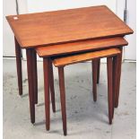 A nest of three teak tables by Bramin, height 47cm.