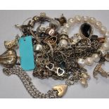 A mixed lot of jewellery to include a silver bracelet with padlock, five silver charms, a silver