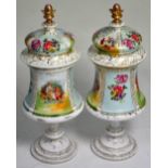 A pair of early 20th century Continental vases and covers with gilt and hand painted decoration