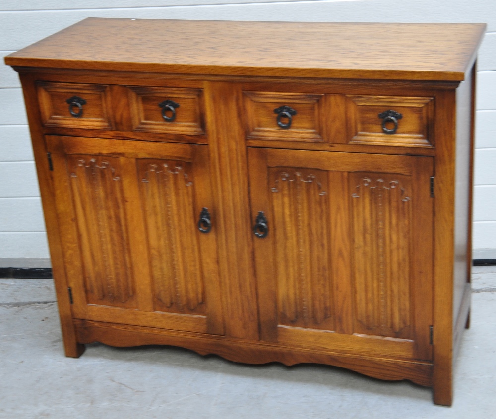 A 20th century oak sideboard, two drawers above heavily carved doors, 90 x 117cm. CONDITION REPORT