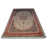 A beige ground Keshan carpet, the central floral motif surrounded by a border of floral sprays, 2.3