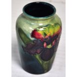 A small Moorcroft orchid pattern baluster vase, blue/green ground with drip glaze decoration,