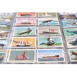 Two folders containing approximately 450 cigarette cards, to include transport, maritime and animal