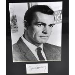 Sean Connery; a black a white photograph with signature to a separate sheet of paper beneath,